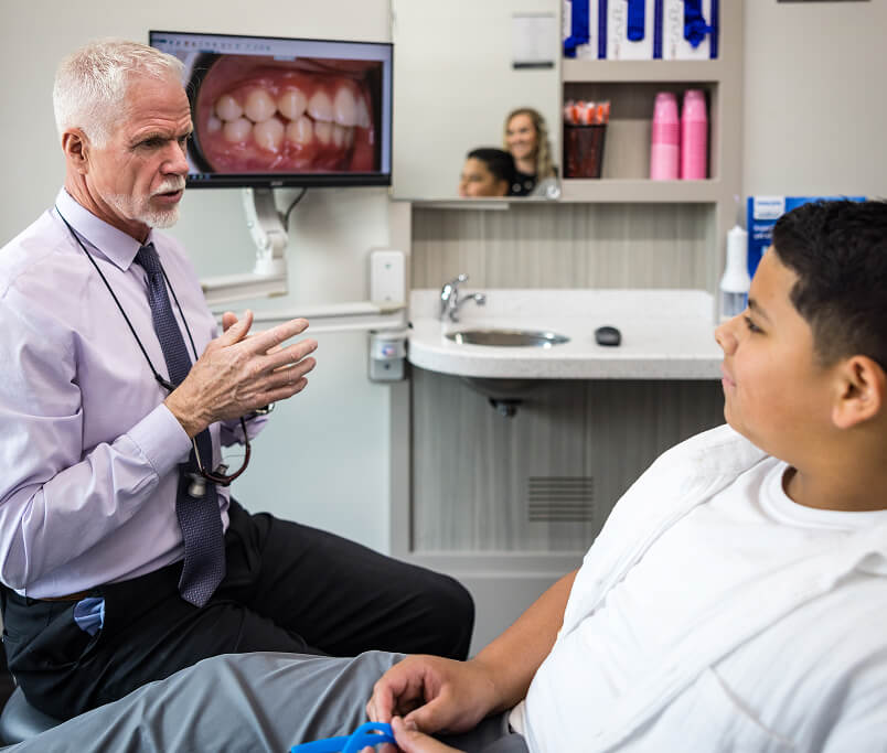 Dr Ritcher talking to a young patient